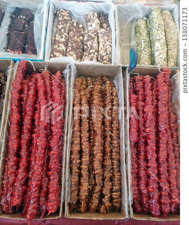 Churchkhela - traditional Georgian sweetness. Tasty oriental sweets churchkhela with nuts, hazelnuts, walnuts, grape juice, honey. Local food market in Tbilisi, Georgia. Churchkhela - traditional Georgian sweetness. Tasty oriental sweets churchkhela with nuts, hazelnuts, walnuts, grape juice, honey. Local food market in Tbilisi, Georgia. 138071173