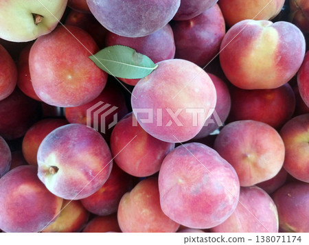 Delicious Bright juicy ripe peaches and green leaves close-up, flat lay 138071174