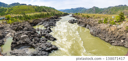 Narrowest and deepest section of Katun river with lava banks in Altai Russia. View from Oroktoy bridge reveals powerful mountain stream cutting through rocky gorge. Narrowest and deepest section of Katun river with lava banks in Altai Russia. View from Oroktoy bridge reveals powerful mountain stream cutting through rocky gorge. 138071417