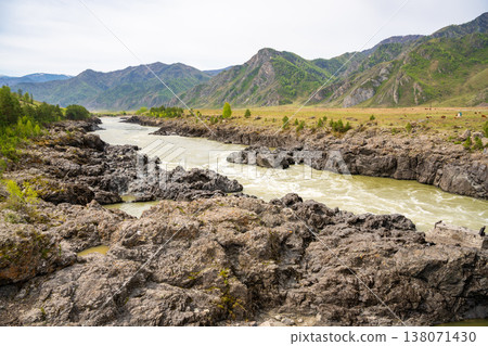Narrowest and deepest section of Katun river with lava banks in Altai Russia. View from Oroktoy bridge reveals powerful mountain stream cutting through rocky gorge. 138071430