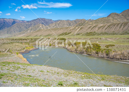 Katun River surrounded by mountains in Chuysky Trakt Altai Russia. Scenic Siberian river flowing through rugged mountain landscape. 138071431