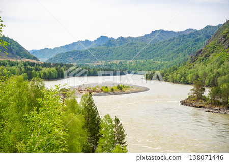 Katun river in spring surrounded by Altai mountains in Russia. Melting waters and awakening nature create vibrant seasonal landscape. Katun river in spring surrounded by Altai mountains in Russia. Melting waters and awakening nature create vibrant seasonal landscape. 138071446