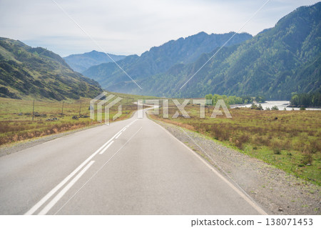 Mountain road running along the Katun river in Altai Russia. Scenic route winding through natural landscapes of the Altai mountains. Mountain road running along the Katun river in Altai Russia. Scenic route winding through natural landscapes of the Altai mountains. 138071453