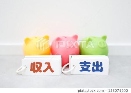 A piggy bank that compares income and expenses, and an image illustrating household budget management. A piggy bank that compares income and expenses, and an image illustrating household budget management. 138071990