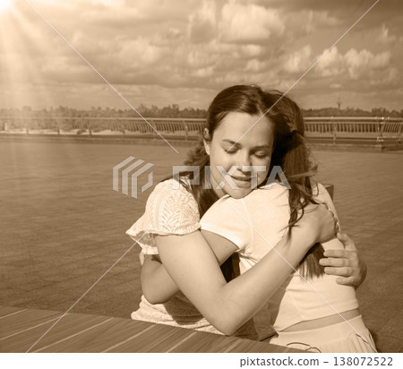 Two girls hugging in the cafe 138072522