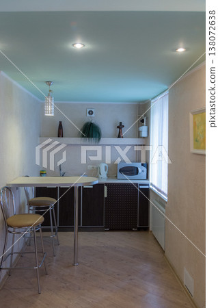 A small modern kitchen with a breakfast bar. A small modern kitchen with a breakfast bar. 138072638