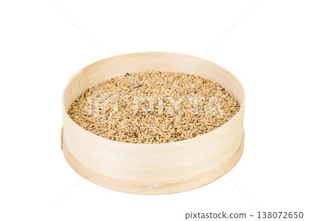 The oat grains are in a wooden bolter. The oat grains are in a wooden bolter. 138072650
