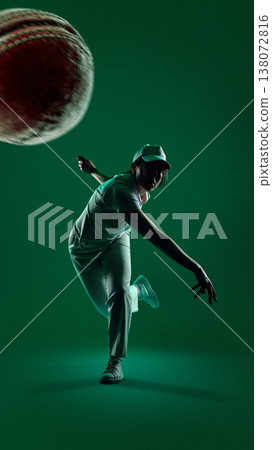 Female cricket player throwing in dramatic green studio lighting with closeup ball shot. Female cricket player throwing in dramatic green studio lighting with closeup ball shot. 138072816
