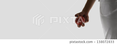 Female hand holding cricket ball minimal isolated banner on white background. Female hand holding cricket ball minimal isolated banner on white background. 138072833