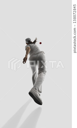 Female cricket player back view releasing ball isolated in studio. Female cricket player back view releasing ball isolated in studio. 138072845