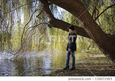 A young woman walks through the autumn park. A young woman walks through the autumn park. 138072905