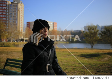 A young woman walks through the autumn park. A young woman walks through the autumn park. 138072914