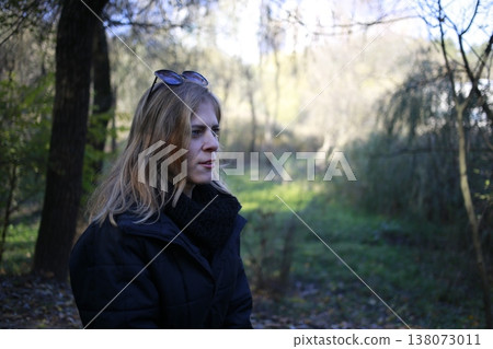 A young woman walks through the autumn park. A young woman walks through the autumn park. 138073011