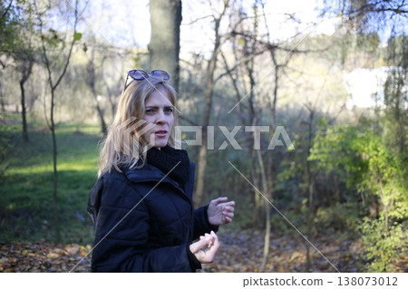 A young woman walks through the autumn park. A young woman walks through the autumn park. 138073012