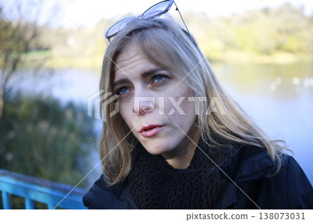 A young woman walks through the autumn park. A young woman walks through the autumn park. 138073031