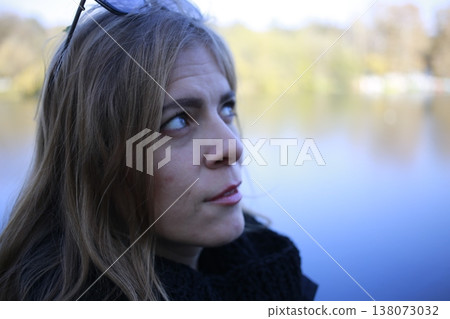 A young woman walks through the autumn park. A young woman walks through the autumn park. 138073032