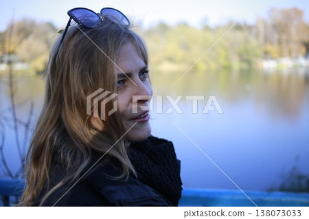 A young woman walks through the autumn park. A young woman walks through the autumn park. 138073033