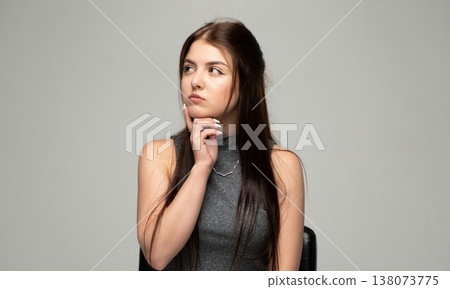 Young woman thinking deeply, contemplating idea, looking away with a pensive expression, feeling indecisive and reflective Young woman thinking deeply, contemplating idea, looking away with a pensive expression, feeling indecisive and reflective 138073775