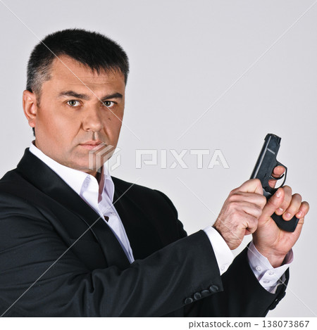 Businessman holding gun Businessman holding gun 138073867