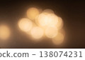 A dreamy golden bokeh and particles of light against a warm, creamy abstract background. 138074231