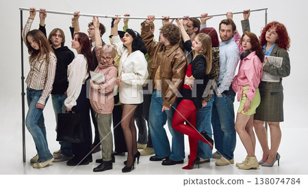 Passengers standing tightly packed holding rail in crowded public transport scene Passengers standing tightly packed holding rail in crowded public transport scene 138074784