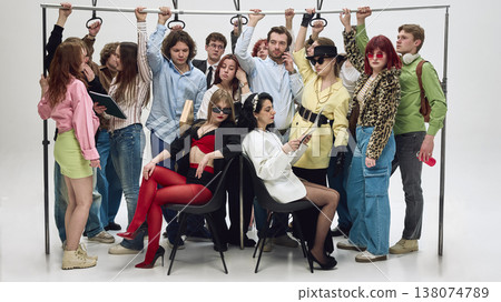 Crowded group of people holding handrails standing tightly in subway carriage. Crowded group of people holding handrails standing tightly in subway carriage. 138074789
