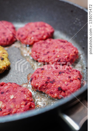A scene showing the preparation of a mouthwatering plant-based hamburger. 138075472