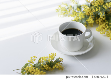 A spring table photo featuring mimosa, coffee, and light and shadow. (Copy space available) A spring table photo featuring mimosa, coffee, and light and shadow. (Copy space available) 138076821