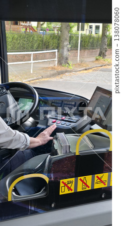 Berlin, Germany - August 07, 2025: Bus driver operating vehicle with modern dashboard and controls Berlin, Germany - August 07, 2025: Bus driver operating vehicle with modern dashboard and controls 138078060