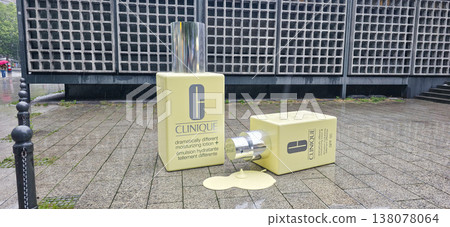 Berlin, Germany - July 17, 2025: Clinique skincare product display with spilled lotion on urban pavement Berlin, Germany - July 17, 2025: Clinique skincare product display with spilled lotion on urban pavement 138078064