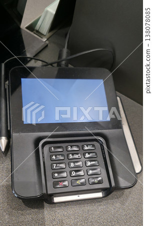 Berlin, Germany - August 11, 2025: Black touchscreen payment terminal with blank screen and keypad layout Berlin, Germany - August 11, 2025: Black touchscreen payment terminal with blank screen and keypad layout 138078085
