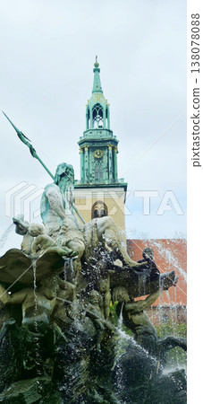 Berlin, Germany - August 16, 2025: Neptune fountain with clock tower in background and flowing water Berlin, Germany - August 16, 2025: Neptune fountain with clock tower in background and flowing water 138078088