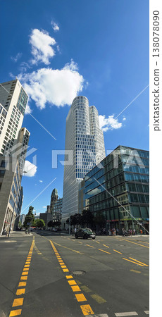 Berlin, Germany - August 18, 2025: Modern skyscraper in urban setting with blue sky Berlin, Germany - August 18, 2025: Modern skyscraper in urban setting with blue sky 138078090