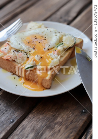 Open-faced sandwich with potato salad and a runny fried egg. Open-faced sandwich with potato salad and a runny fried egg. 138078472