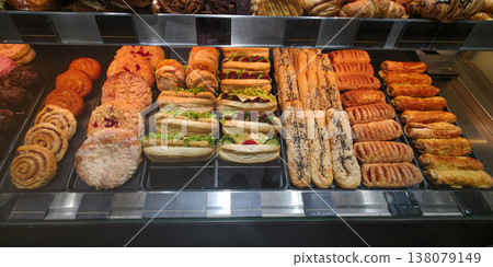 Assorted baked goods displayed in a bakery showcasing various pastries 138079149