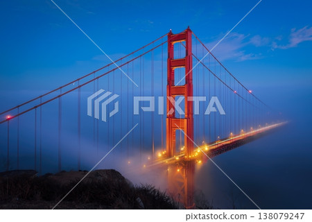 Golden Gate Bridge at blue hour surrounded by fog and clouds in San Francisco. Golden Gate Bridge at blue hour surrounded by fog and clouds in San Francisco. 138079247