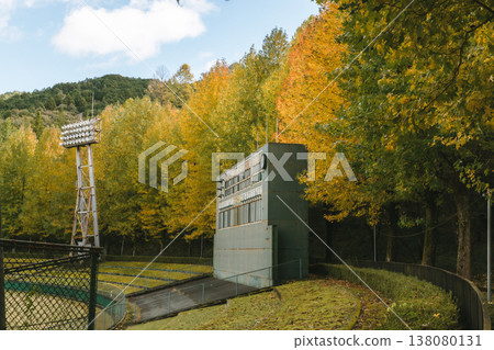 A deserted baseball field and scoreboard bathed in autumn colors. 138080131