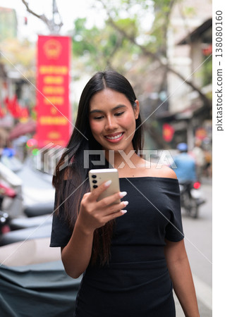 Thai Woman Using Smartphone on Hanoi Street Vietnam 138080160
