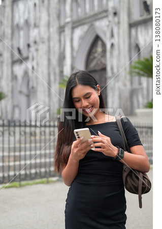 Thai Woman Using Smartphone at St Joseph's Cathedral Hanoi Vietnam 138080173