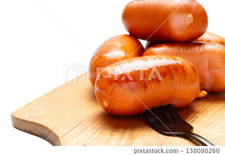 Appetizing grilled sausages on a cutting board close-up Appetizing grilled sausages on a cutting board close-up 138080260