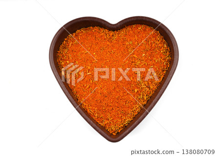 Cajun seasoning in a heart shaped bowl on a white background Cajun seasoning in a heart shaped bowl on a white background 138080709