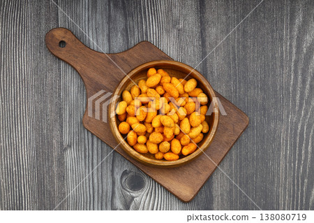 Crunchy Coated Peanuts in a Wooden Bowl on Wooden Background Crunchy Coated Peanuts in a Wooden Bowl on Wooden Background 138080719