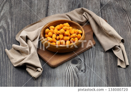 Crunchy Coated Peanuts in a Wooden Bowl on Wooden Background Crunchy Coated Peanuts in a Wooden Bowl on Wooden Background 138080720