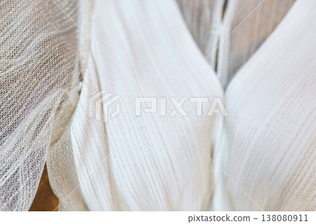 Closeup of airy bridal dress gown bodice with shimmering sheer sleeves Closeup of airy bridal dress gown bodice with shimmering sheer sleeves 138080911
