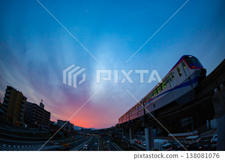 A commuter train at sunset and a city street scene on the way home. A commuter train at sunset and a city street scene on the way home. 138081076