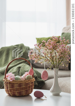Easter Basket with Ester Eggs,  Plush Bunny and Spring Decor on White Table intoCozy Living Room 138081101