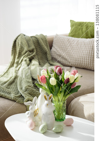 Living Room Decorated Easter Eggs with Bunny Figurines and Tulips. Cozy Spring Holiday Arrangement Living Room Decorated Easter Eggs with Bunny Figurines and Tulips. Cozy Spring Holiday Arrangement 138081115