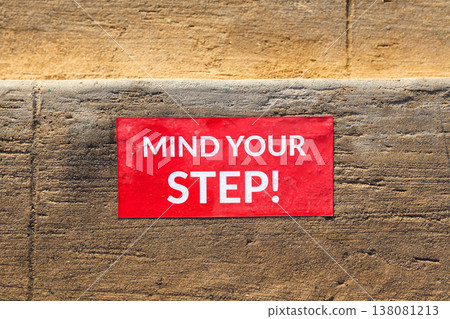 The inscription on the steps of the stairs reads Watch your step The inscription on the steps of the stairs reads Watch your step 138081213