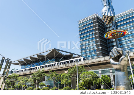 A train on the Wenhu or Brown Line of the Taipei MRT passes by the modern metropolis building in Nangang Software Park Area. A train on the Wenhu or Brown Line of the Taipei MRT passes by the modern metropolis building in Nangang Software Park Area. 138081845