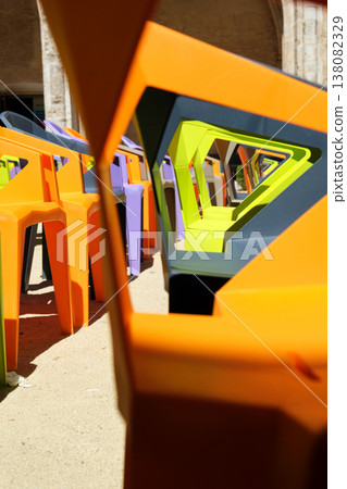rows of colorful plastic chairs and an open-air auditorium 138082329